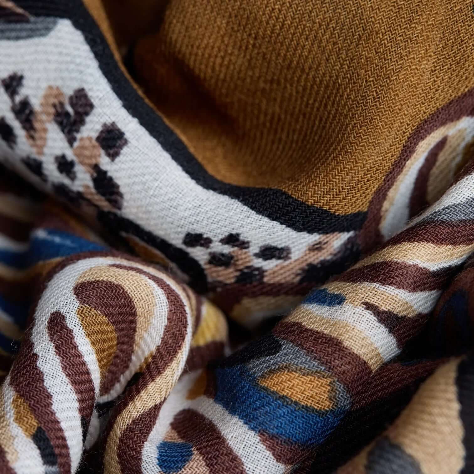 Close-up of Foulard Quadrato Western Marrone with unique colorful patterns, ideal for enhancing any outfit.