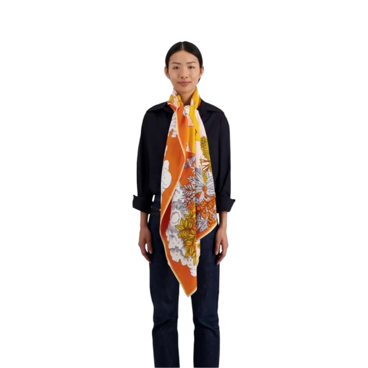 Model wearing the Sciarpa Magnus Summer scarf, featuring vibrant floral patterns in cotton and silk.