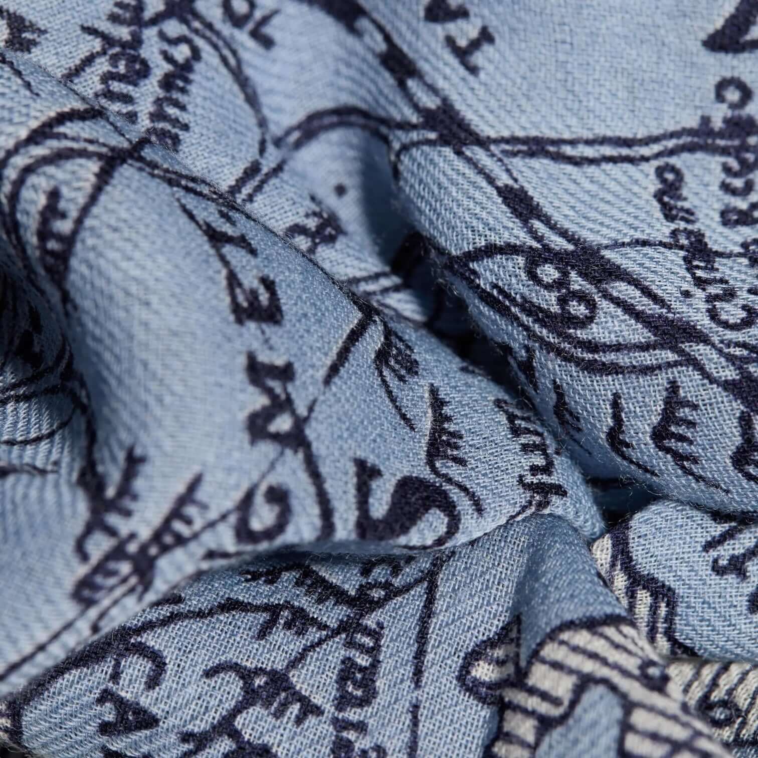 Close-up of Foulard Quadrato Mappemonde Blu featuring a unique blue and navy world map design, perfect for stylish outfits.