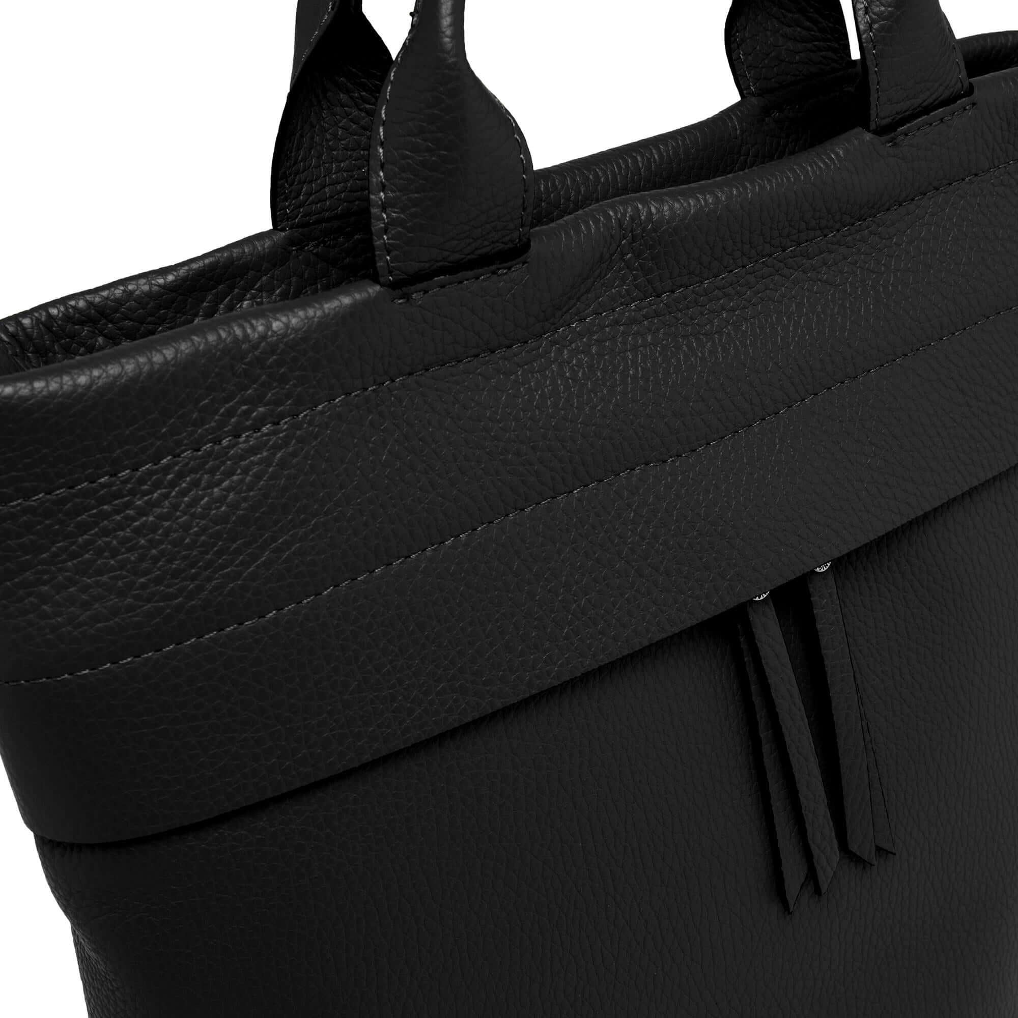 Close-up of Andrea black leather backpack with double handles and textured finish.