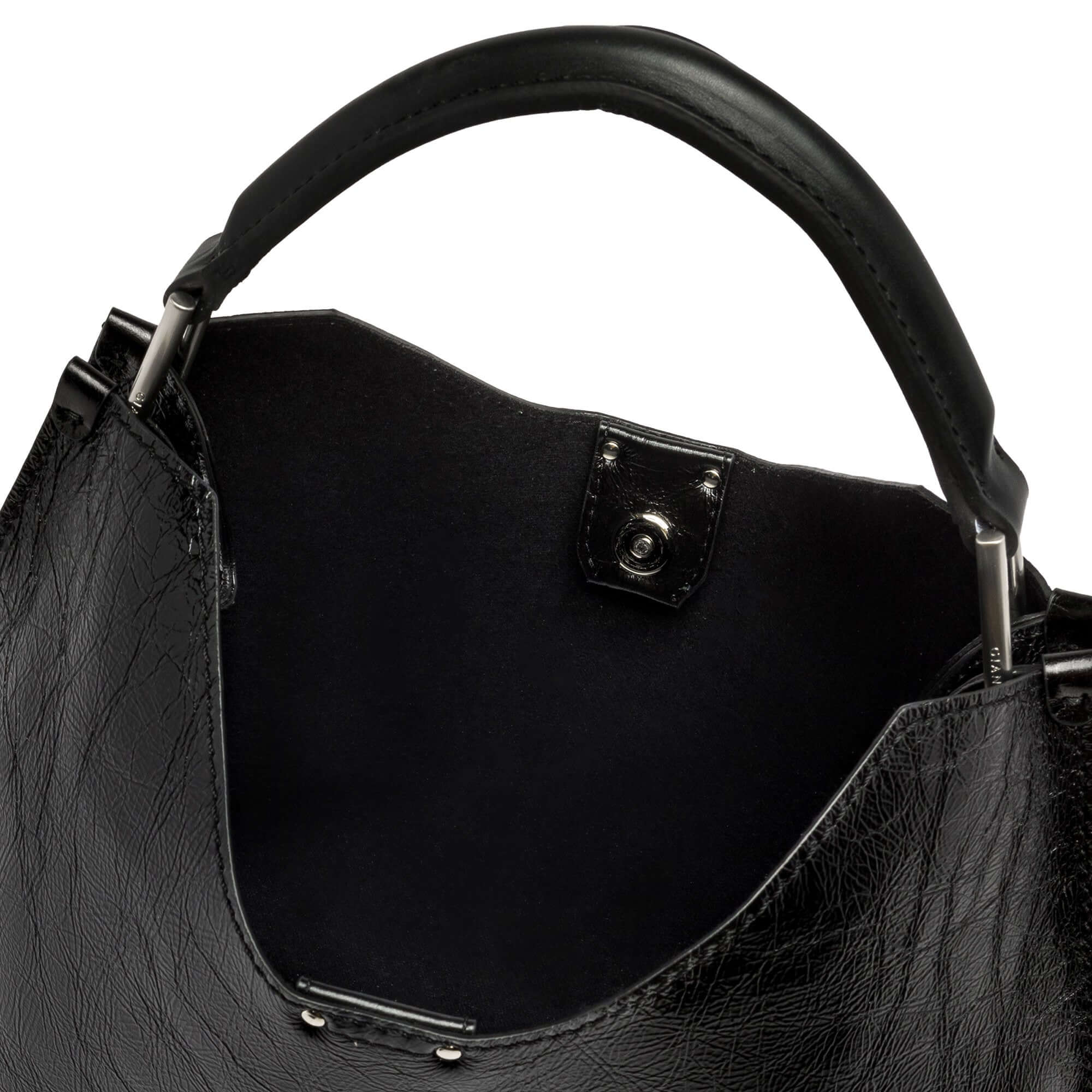 Close-up view of the black leather interior and handle of the Gianni Chiarini Aurora handbag.