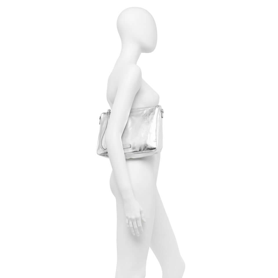 Profile view of the Nora Pouch handbag by Gianni Chiarini in metallic leather, showcased on a mannequin.