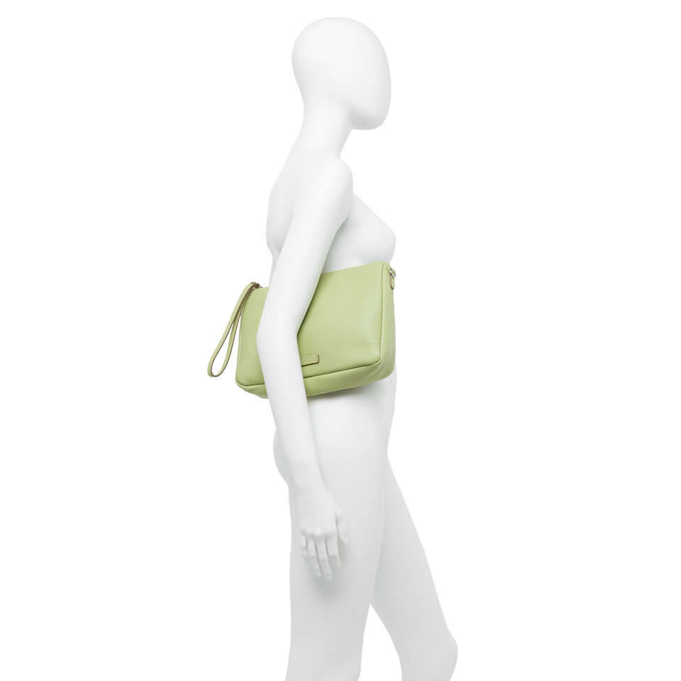 Nora Pouch by Gianni Chiarini in light green, features adjustable strap and zip closure, displayed on a mannequin side view.