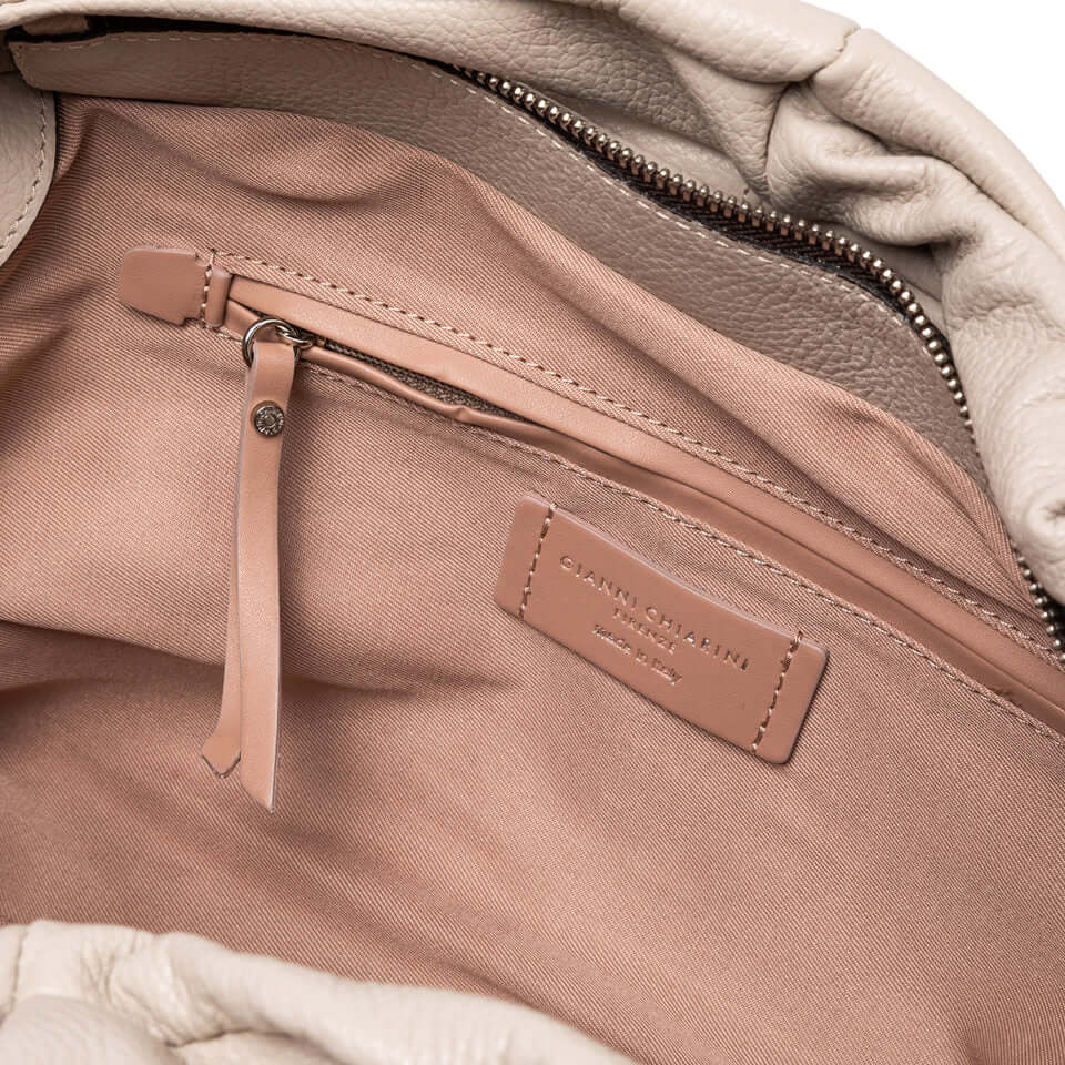 Interior view of AGNESE medium-sized leather bag showcasing zip pocket and soft lining.