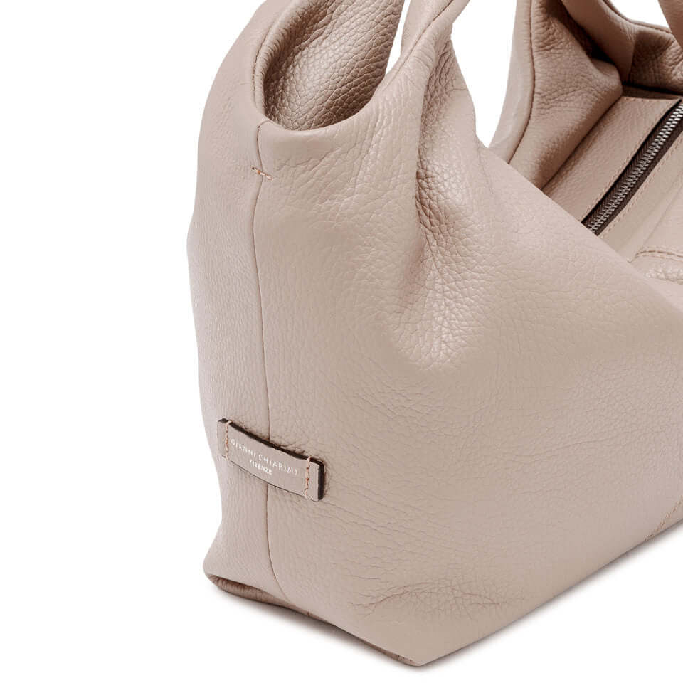 Agnese medium-size bag in grana dollaro leather with double handles and top zip closure, perfect for hand or crossbody carry.