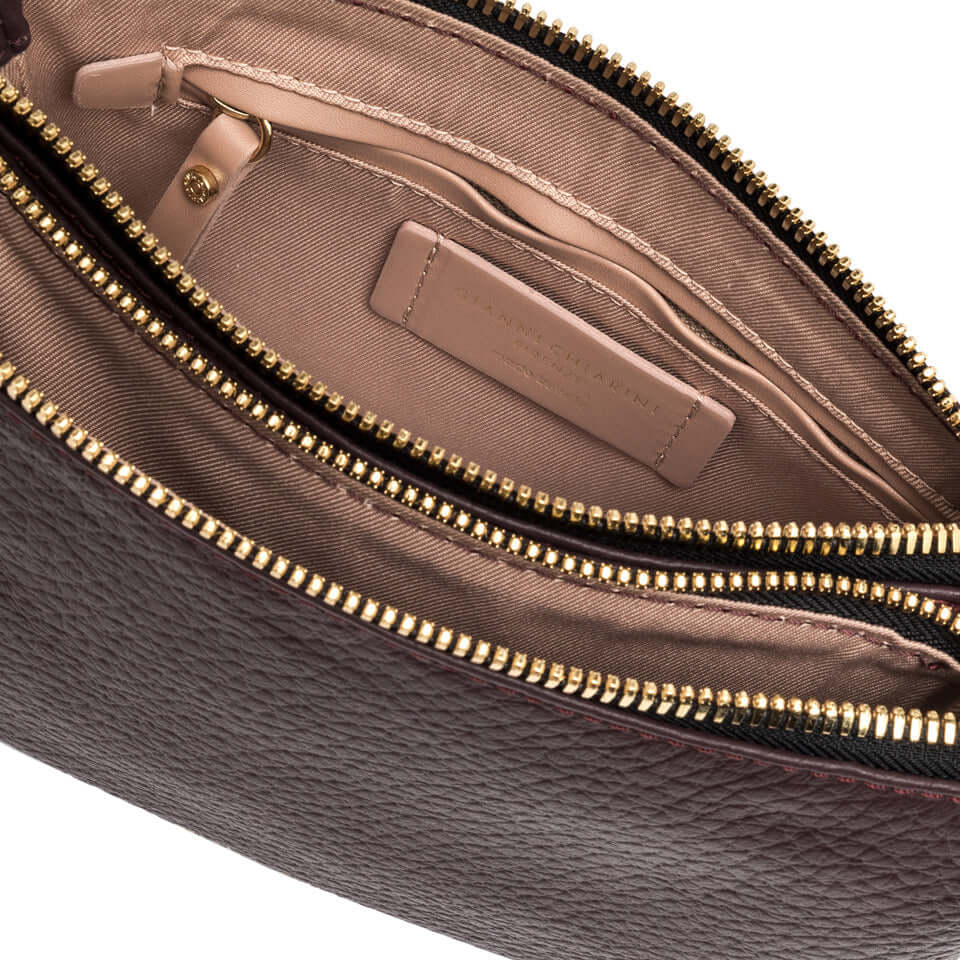 Interior view of the Frida handbag, featuring a luxurious leather finish and spacious zip compartments.
