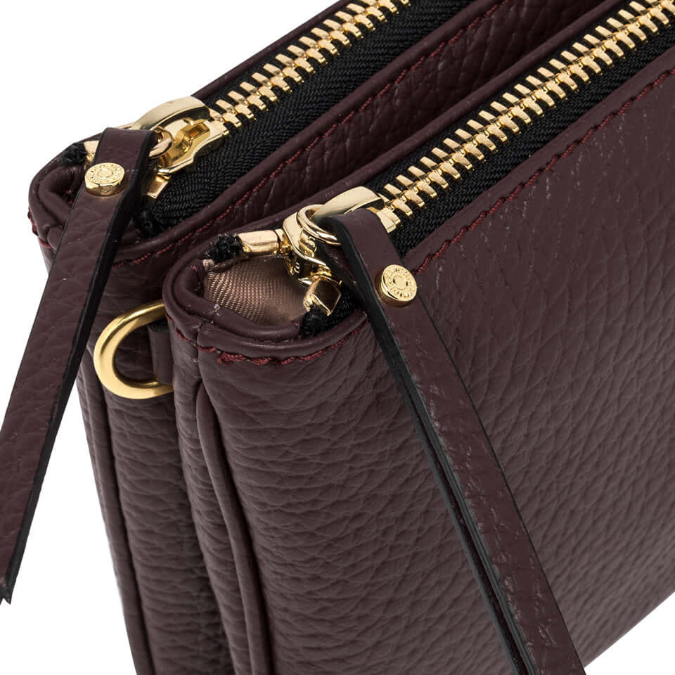 Close-up of Frida shoulder bag featuring two zip compartments in premium textured leather.
