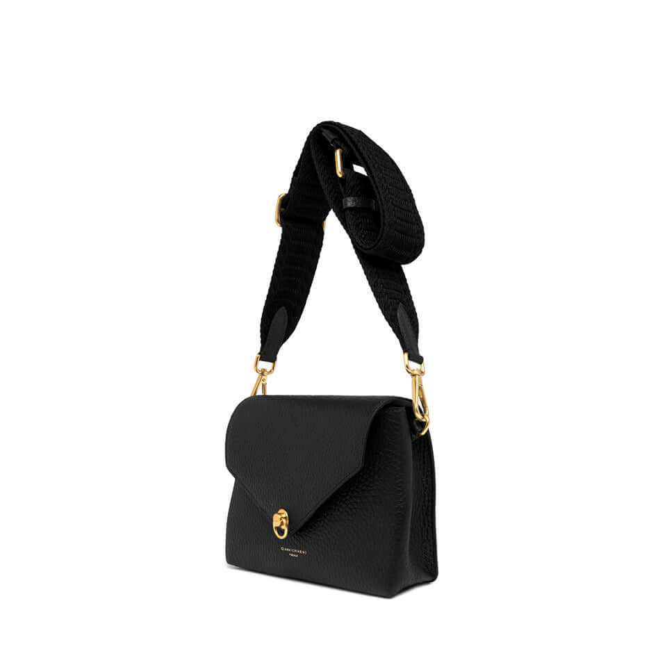 Corallo mini bag in black leather with magnetic closure and decorative ring, featuring a woven fabric strap.
