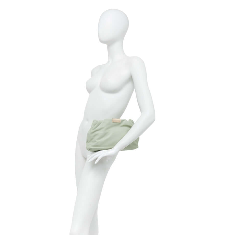 Elegant Perla bag in soft green, showcased on a mannequin, highlighting its chic design and versatility.