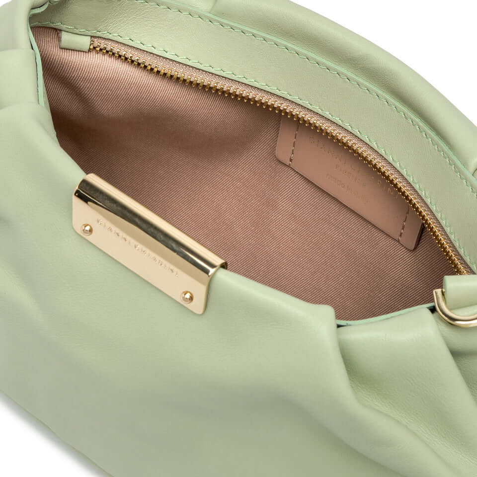 Inside view of the elegant Perla handbag showing soft interior lining and logo detail.