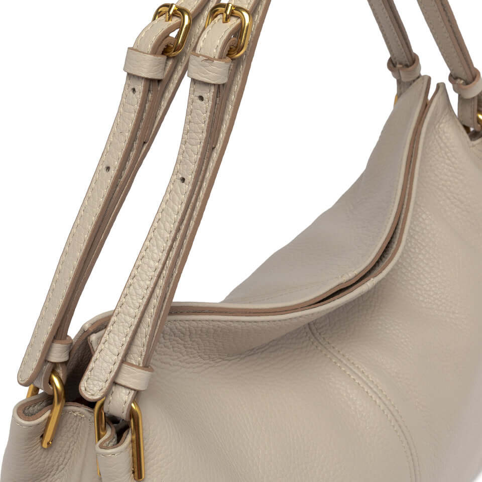 Close-up of Leila shoulder bag with textured leather and gold-tone hardware details, showcasing minimalist design.