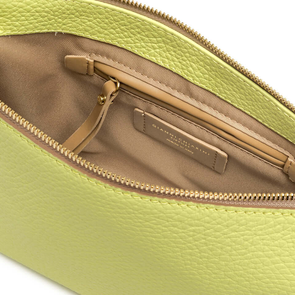 Close-up view of the interior of the Brooke handbag in green, featuring zip pocket and soft lining.