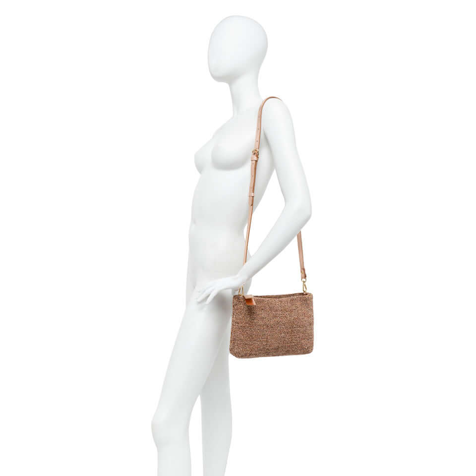 La Brenda pochette by Gianni Chiarini, a woven fabric clutch with removable chain, shown on a mannequin.