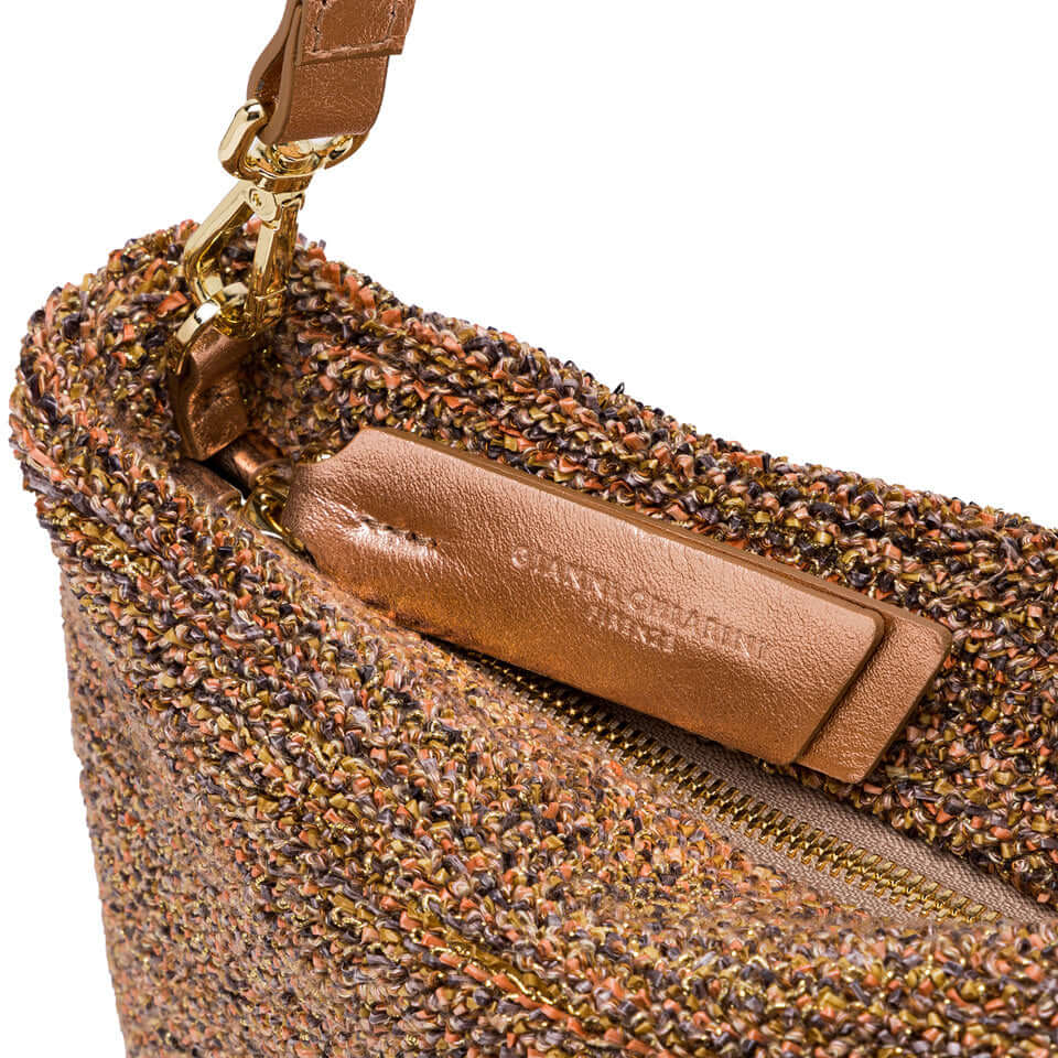 Close-up of the BRENDA pochette by Gianni Chiarini, featuring textured fabric and removable chain detail.