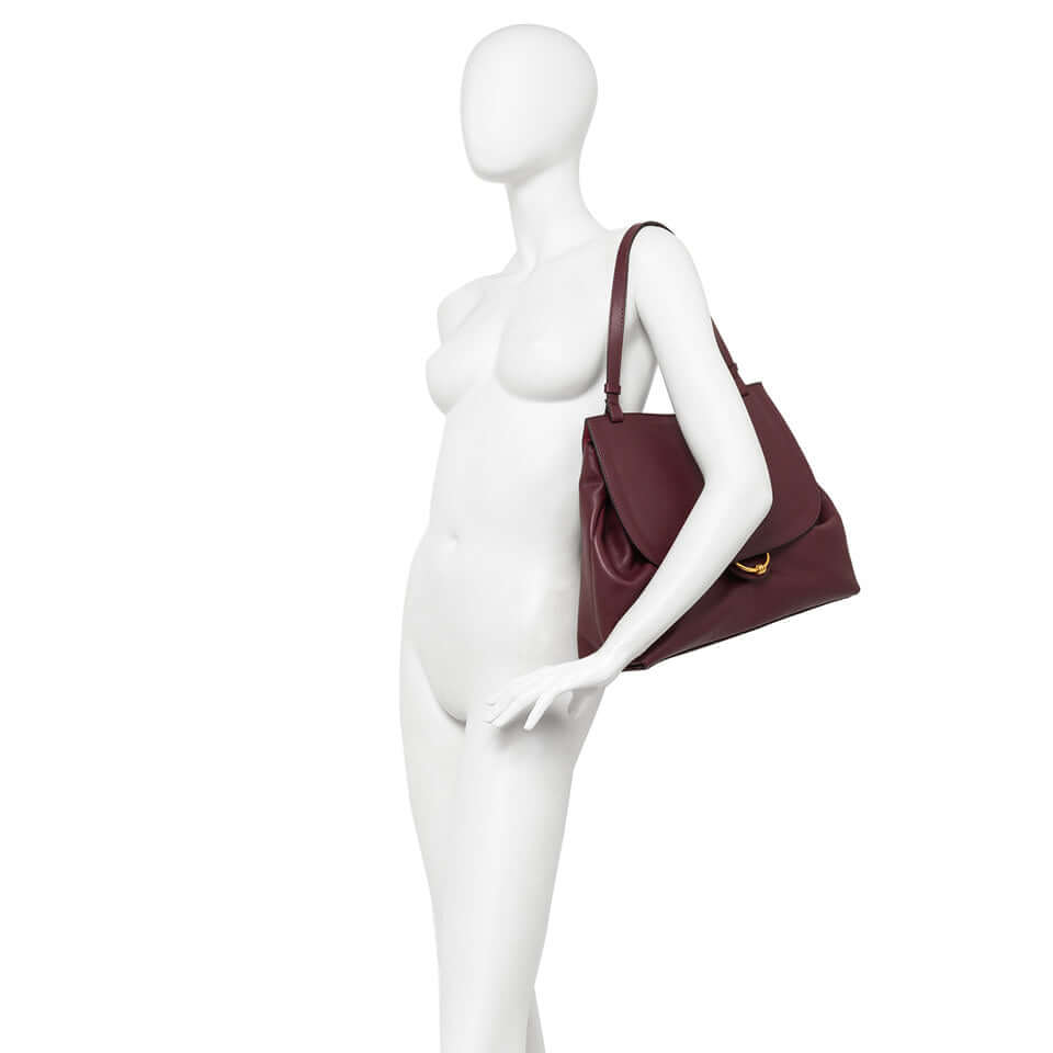 Marlene handbag by Gianni Chiarini in burgundy leather, showcased on a mannequin with stylish design and double carrying option.