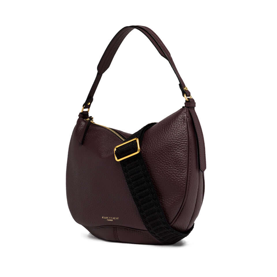 Chiara vintage-style leather handbag in dark burgundy with a removable woven strap, ideal for cross-body wear.
