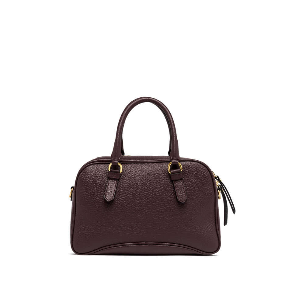 Chiara vintage-inspired leather handbag in dark brown with dual handles and zipper closure.