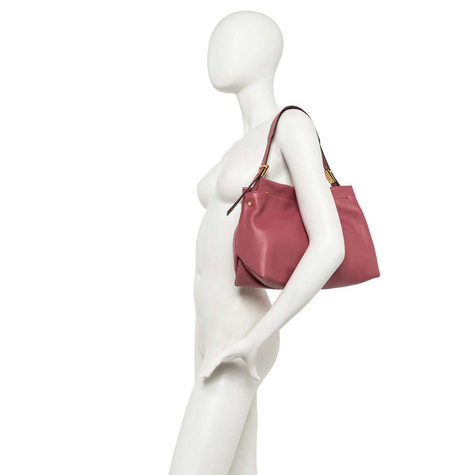 Matilde shoulder bag in soft pink leather, stylish and practical with gold accents and dual carrying options.