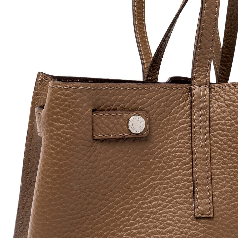 Close-up of ALTEA leather handbag featuring textured brown leather and stylish handle.