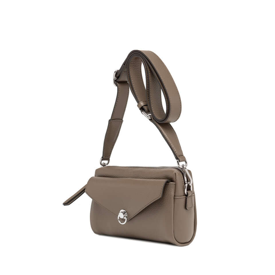 Deva bag in hammered leather with removable cross-body strap and zip closure, showcasing stylish practicality.