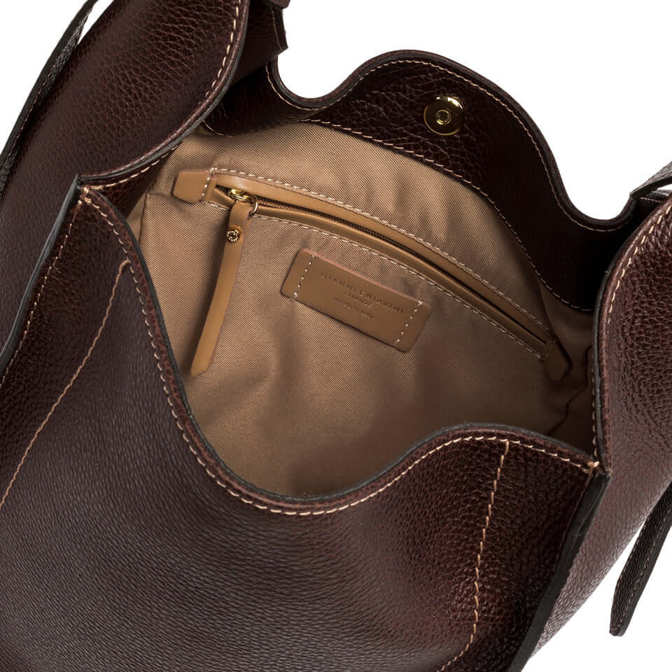 Interior view of OLLY bag by Gianni Chiarini, featuring a brown textured leather finish and inner pocket.