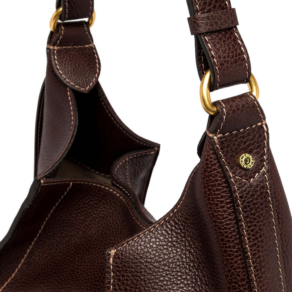 Detail of Olly bag by Gianni Chiarini, featuring textured brown leather and sturdy shoulder strap hardware.