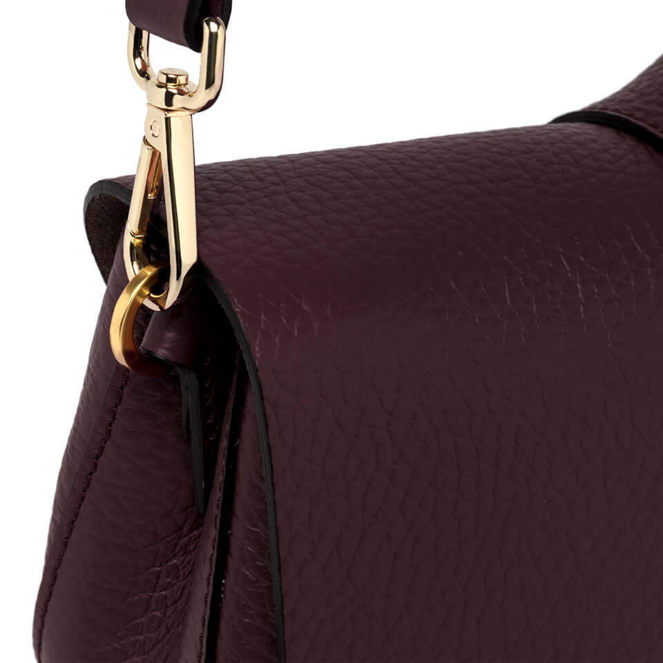 Close-up of the Helena Round bag by Gianni Chiarini showcasing the textured leather and gold hardware.