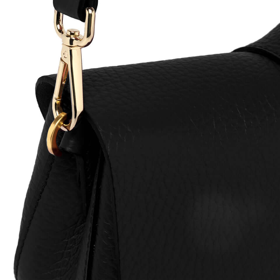 Detail of the Helena Round handbag by Gianni Chiarini showing a gold clasp and textured black leather.
