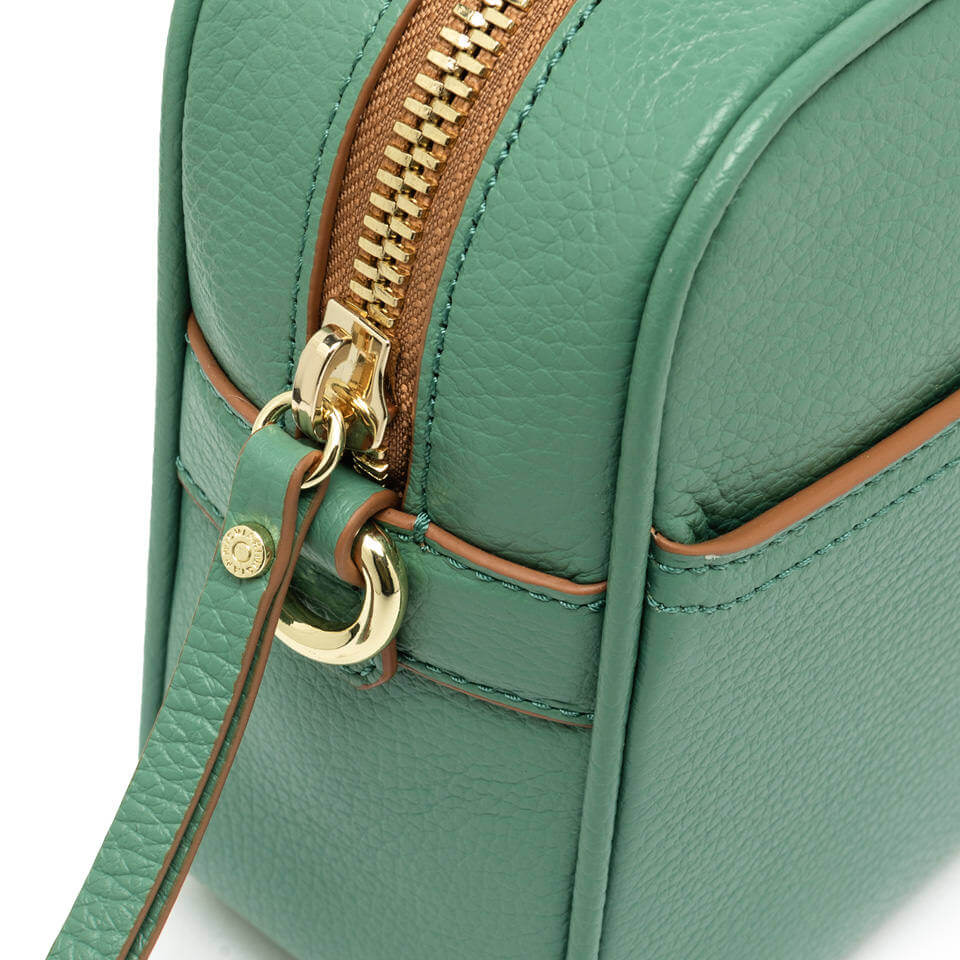 Close-up of the Nina by Gianni Chiarini Firenze, a green leather crossbody bag with gold zipper detail.