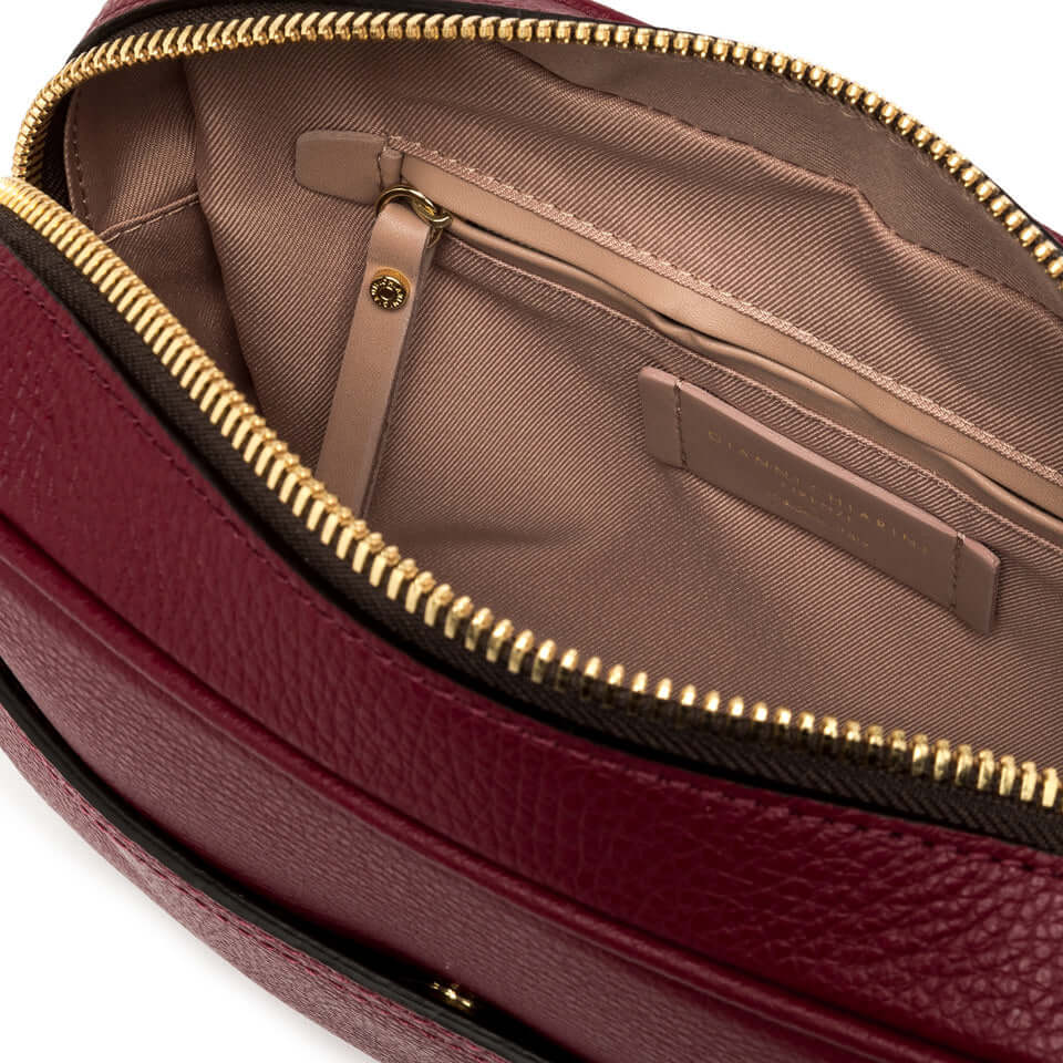 Interior view of La Nina bag by Gianni Chiarini showcasing zip pocket and soft lining in rich burgundy leather.