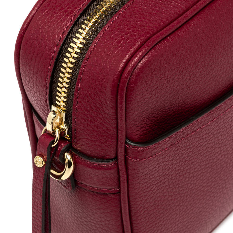 Top view of La Nina by Gianni Chiarini burgundy leather crossbody bag with gold zipper detail.