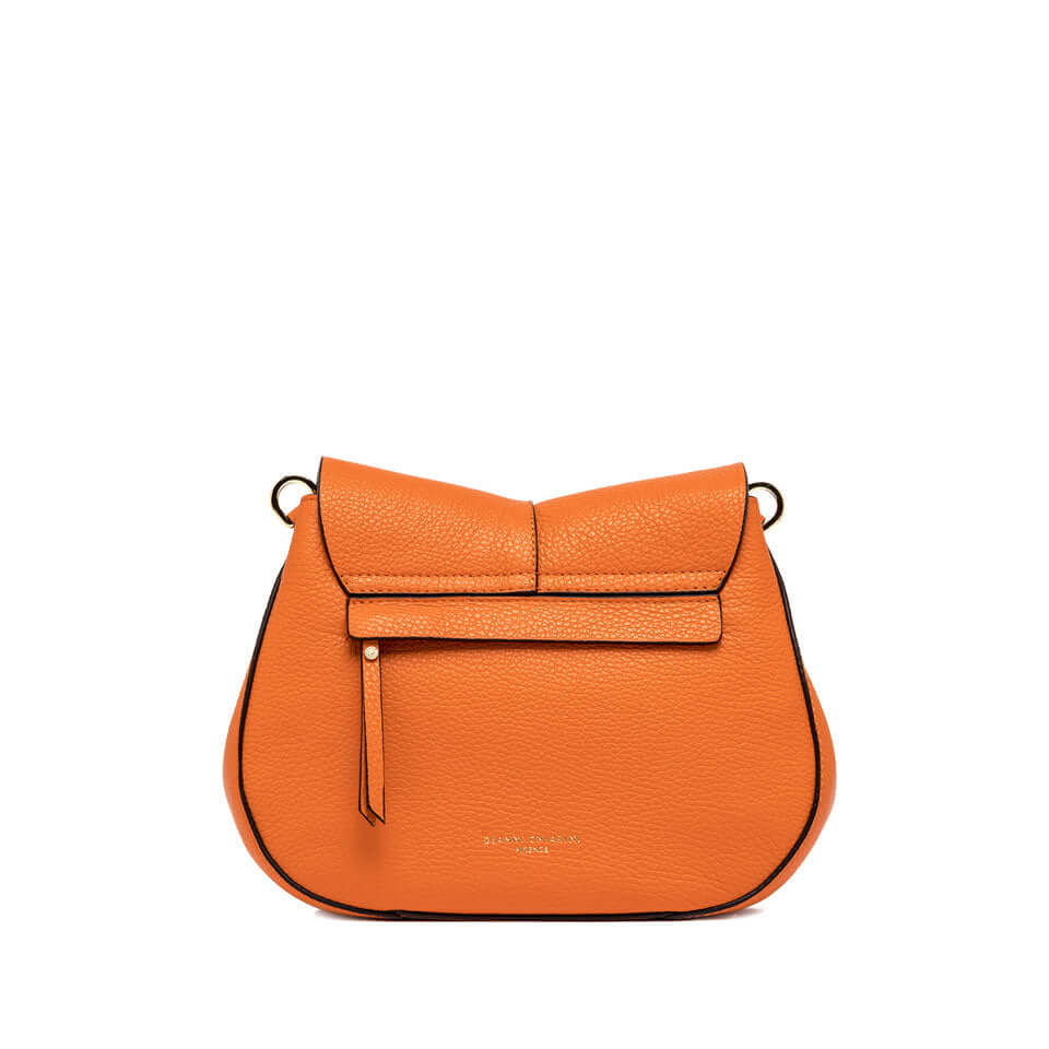 Helena Round bag in vibrant orange leather, featuring a flap with magnet closure and an adjustable strap.