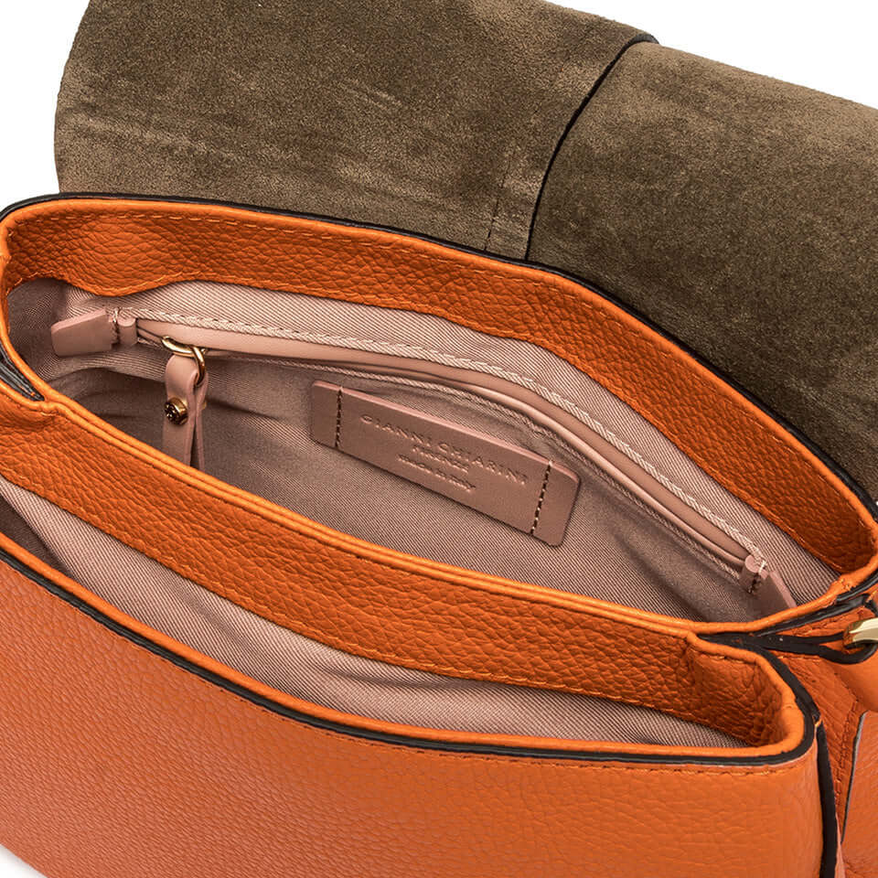 Interior view of Helena Round bag showcasing orange leather compartments and zippered pockets.