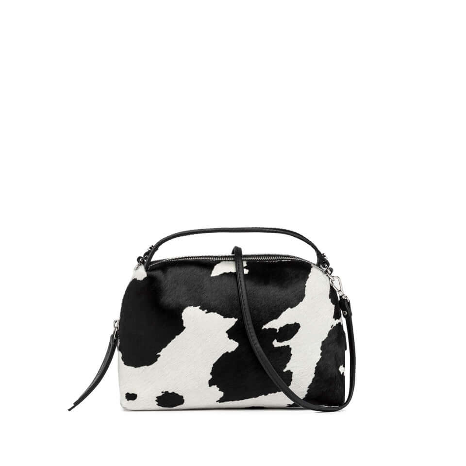 Compact black and white cowhide handbag with double handles and removable strap, stylish and lightweight accessory.