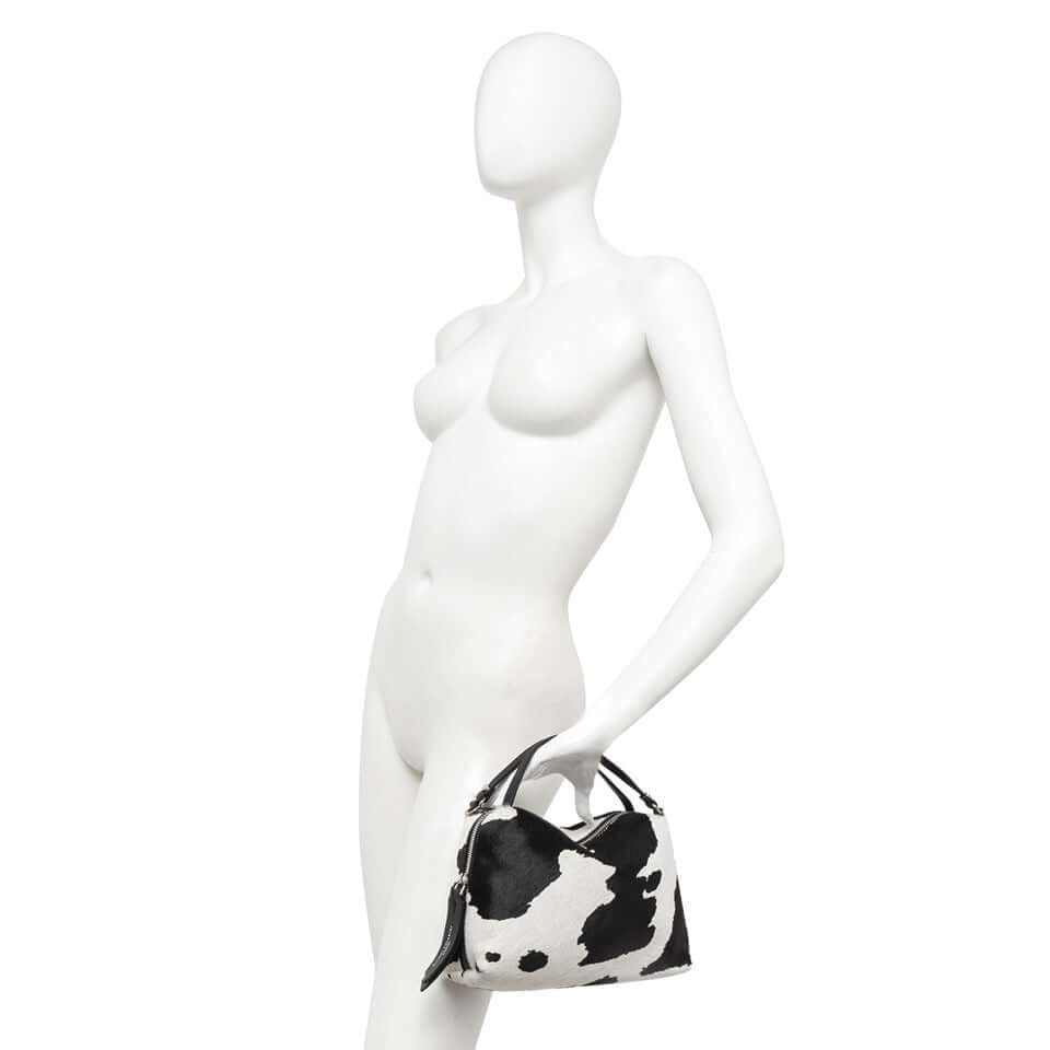 Alifa by Gianni Chiarini handbag in cowhide effect, compact design with dual handles and zip pocket, showcased on a mannequin.