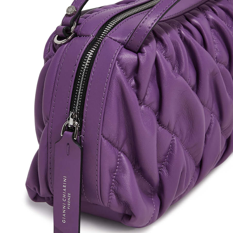 Purple leather handbag with quilted texture and zipper details from Gianni Chiarini, showcasing stylish design.