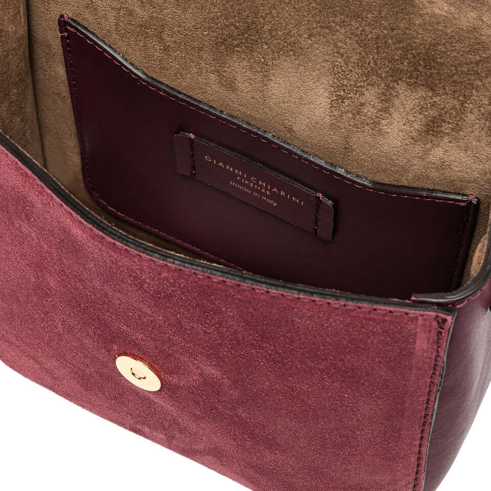 Inside view of Meg crossbody bag showcasing soft suede lining and multi-use flat pocket.
