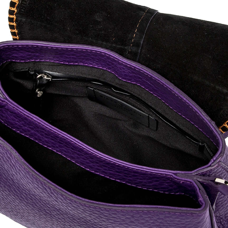Inside view of the HELENA ROUND bag showing a purple leather interior with dual compartments and zippered pocket.