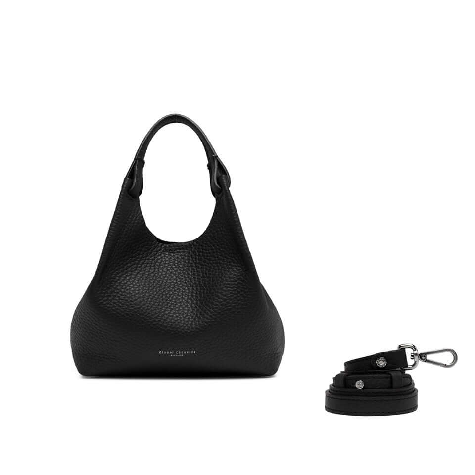 Elegant black leather bag with dual handles and detachable strap, showcasing a timeless design by DUA.