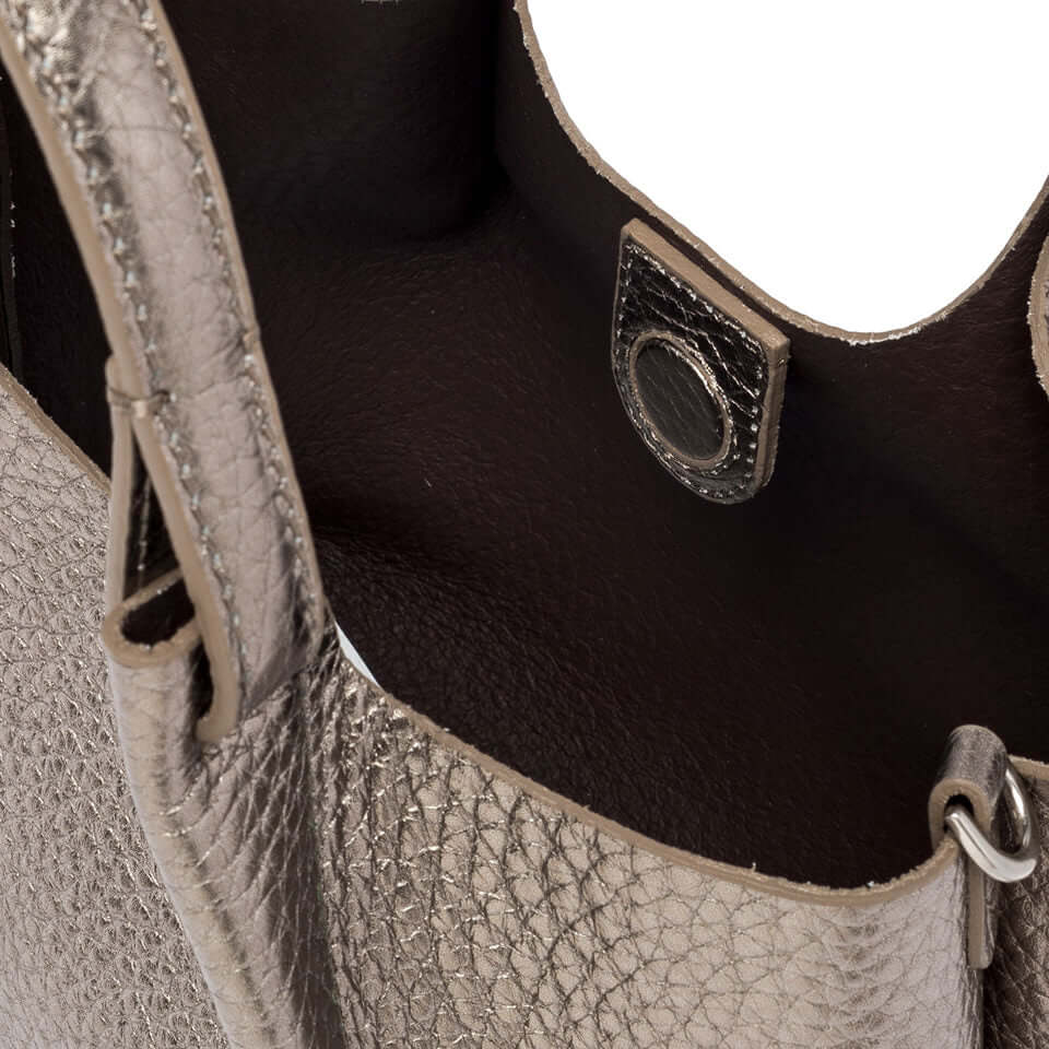 Close-up of the interior of DUA handbag, showcasing textured leather and magnetic closure.
