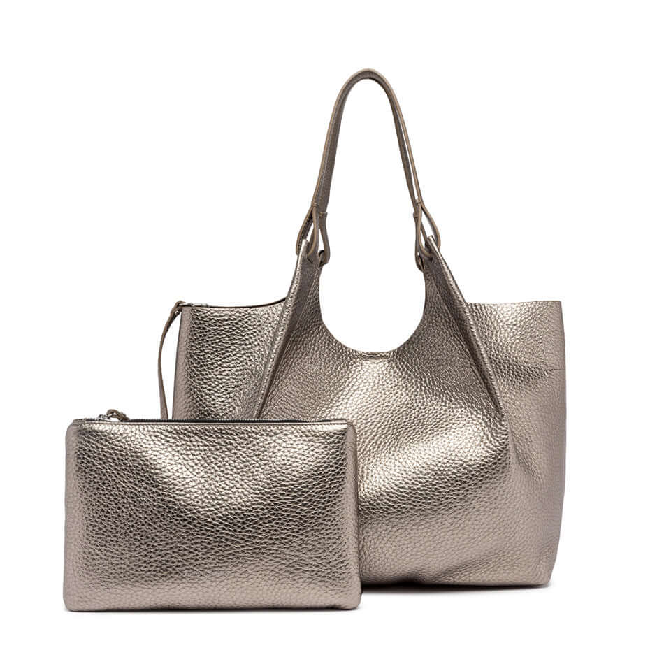 Elegant DUA handbag in metallic leather with matching pouch, perfect for enhancing women's fashion.