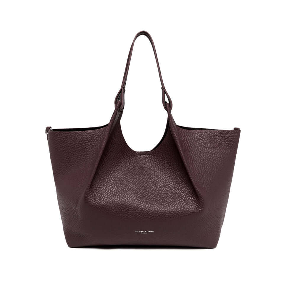 Elegant DUA bag in maxi double grain leather, perfect for enhancing women's looks, with magnet closure and leather handles.
