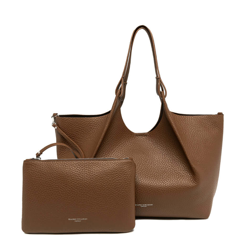 Elegant brown leather DUA tote bag with matching pouch, perfect for enhancing any woman's look.