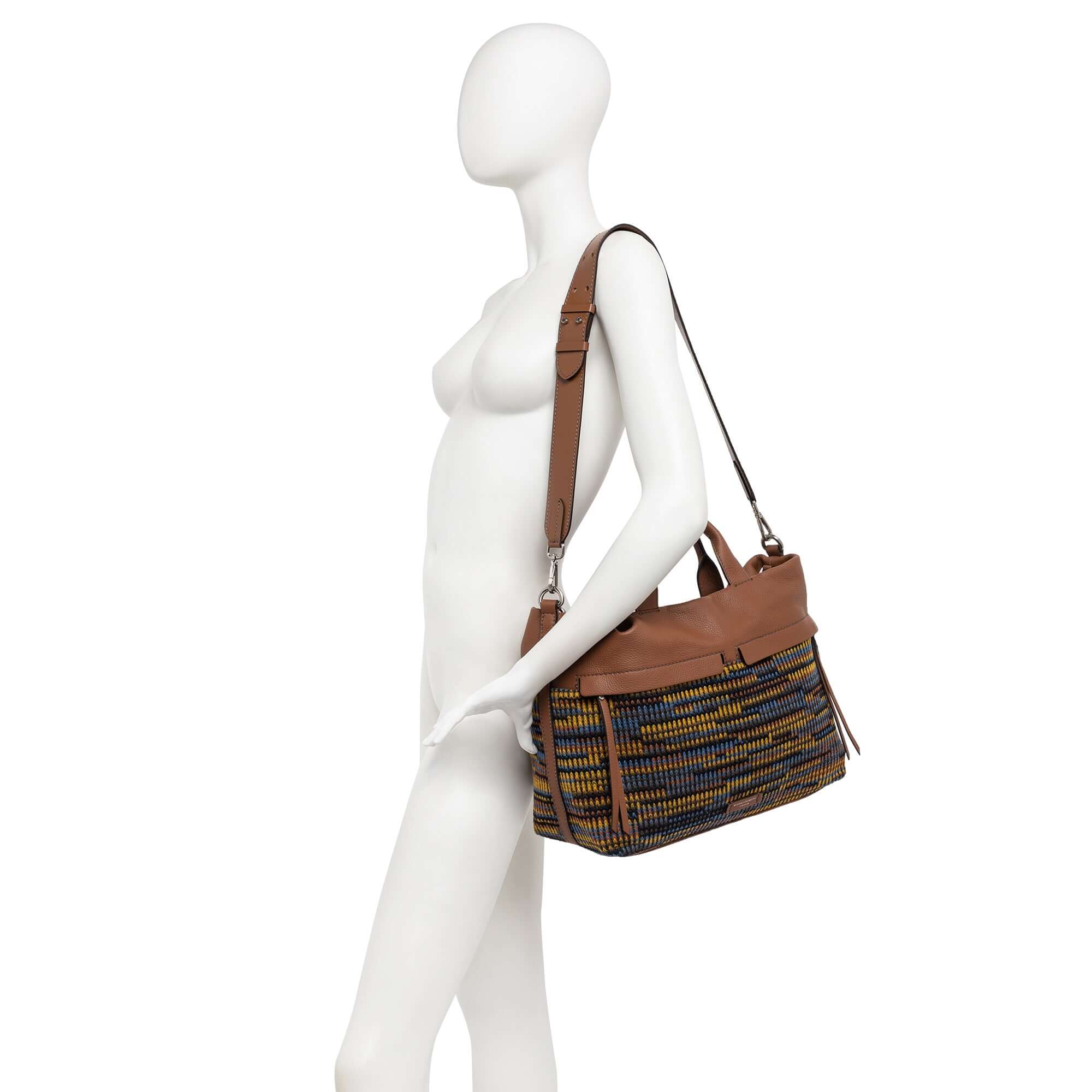 DUNA tote bag with multicolor pattern and leather accents, showcasing front zip pockets and adjustable leather strap.