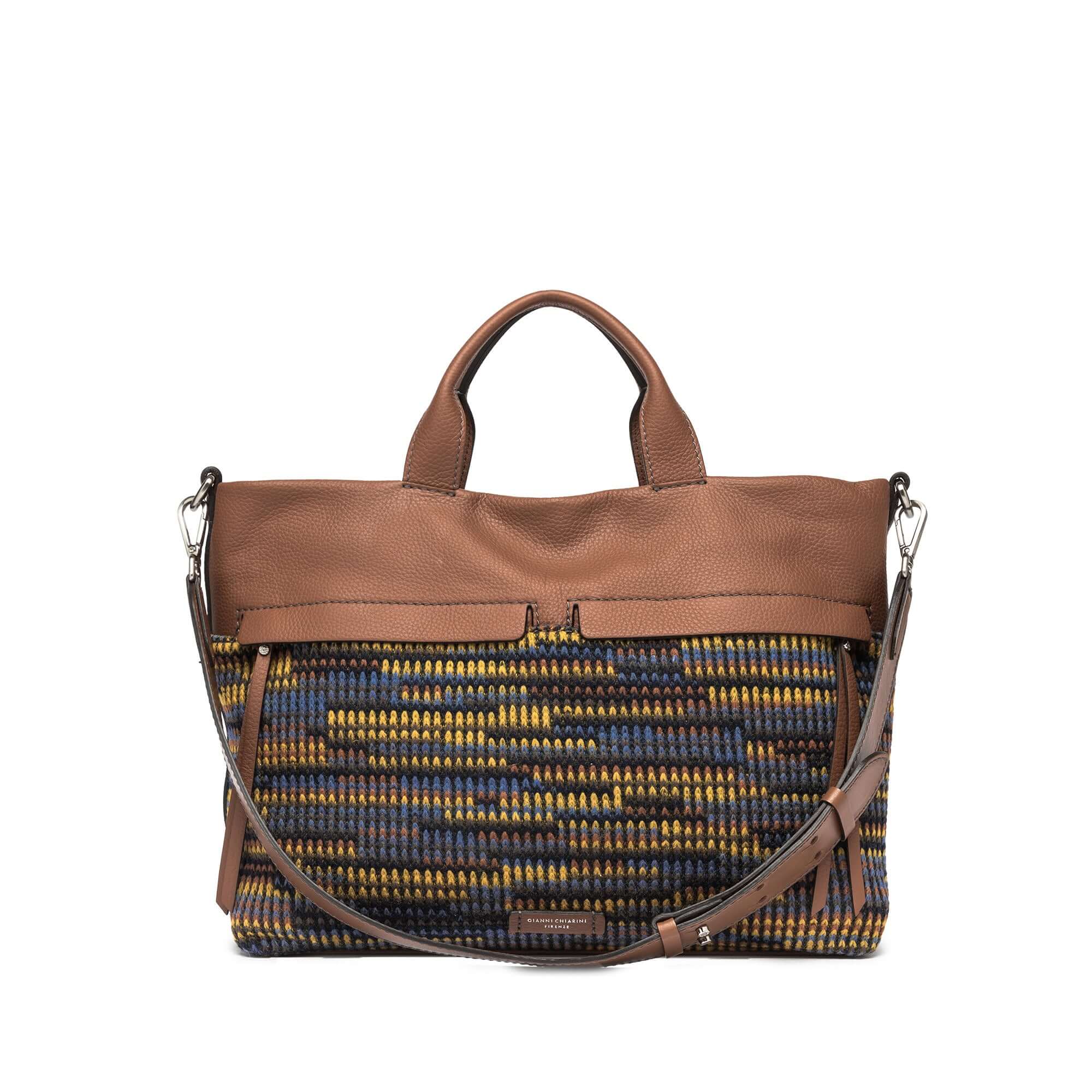 DUNA tote bag with multicolor woven design, leather trim, front zip pockets, and adjustable leather shoulder strap.