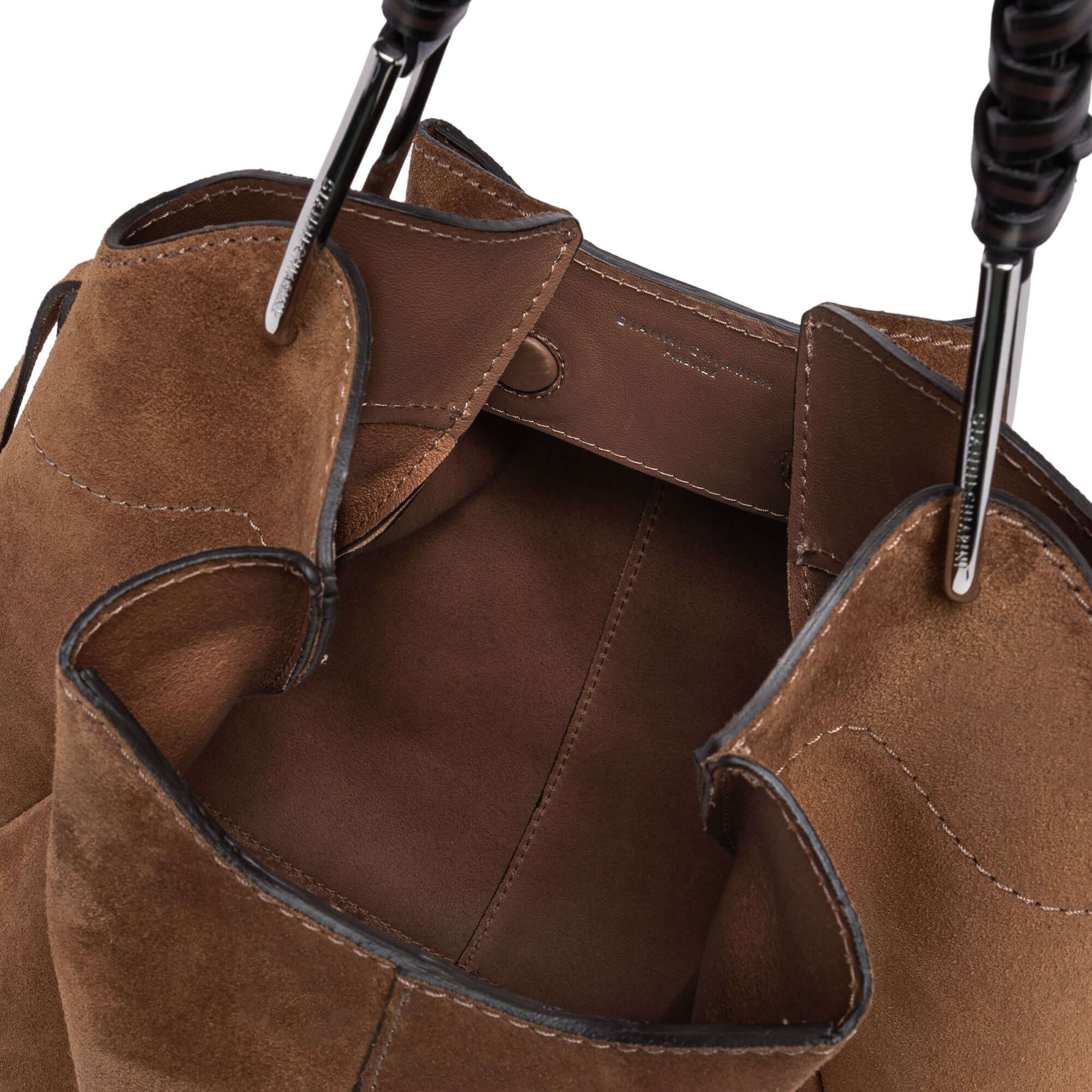Interior view of Gianni Chiarini's Era bag, showcasing soft suede fabric and handmade leather handles.