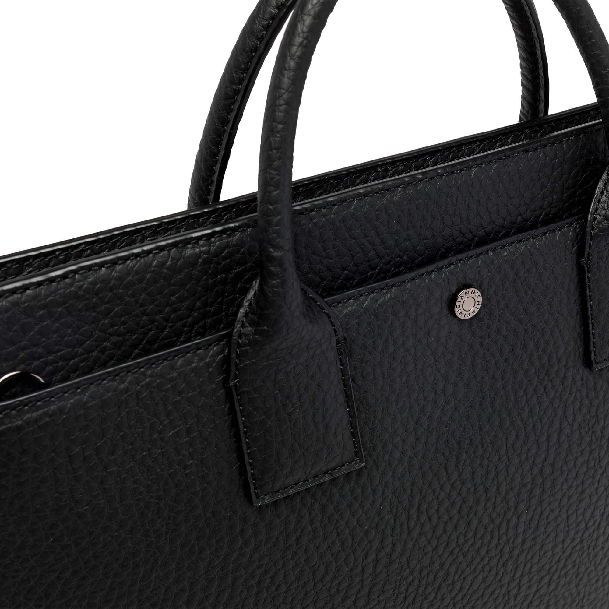 Close-up of a black leather bag with textured finish and logo detail, featuring top handles and zip closure.