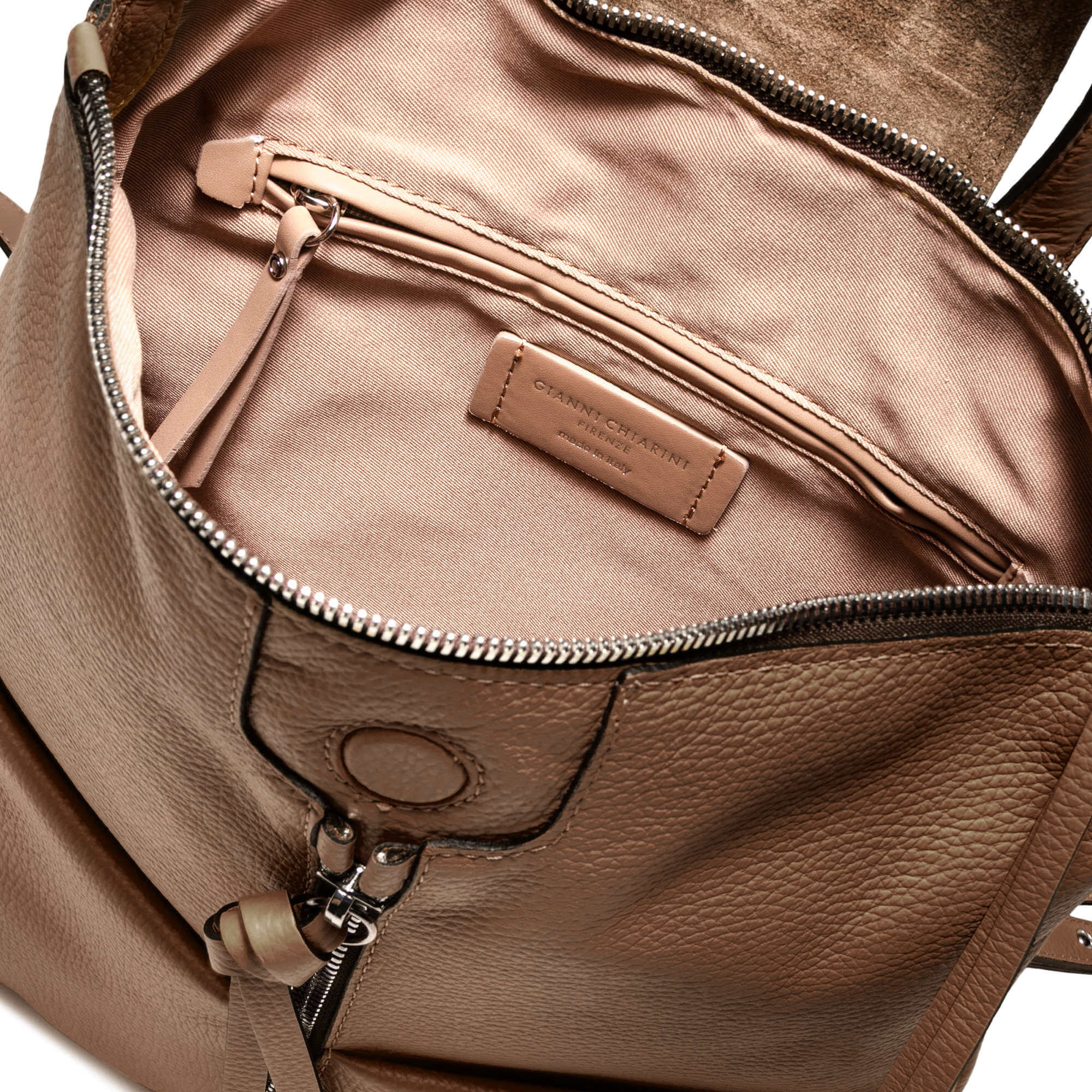 Interior view of GIADA accessory showing zippered pocket and spacious compartments in pebble leather.