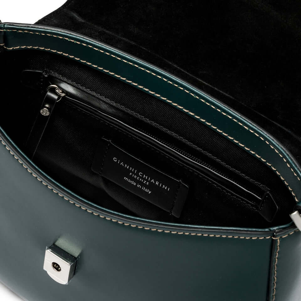 Interior view of GRACE handbag, showcasing zip pocket and Gianni Chiarini label, in stylish green leather.