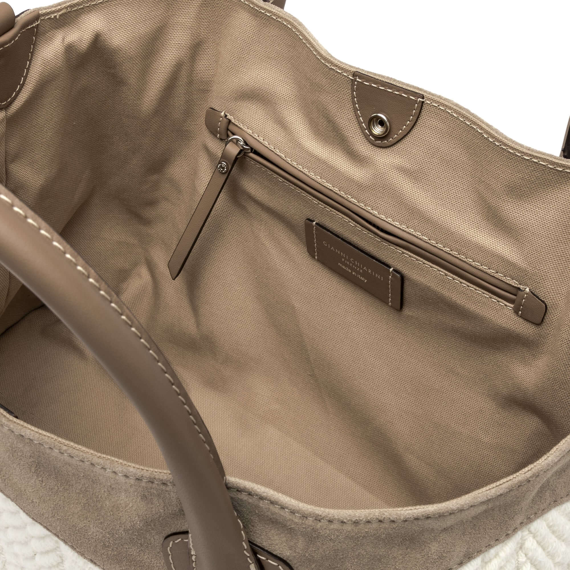 Interior view of JUDY bowling bag, featuring a suede finish, canvas lining, and multi-purpose flat pocket.